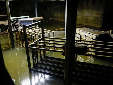 Water continues to flood the basement of McMurray Metals a day after storms dumped heavy...