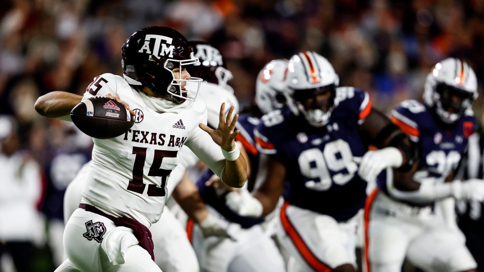 Texas A&M quarterback Conner Weigman (15) rolls out to pass against Auburn during the first...