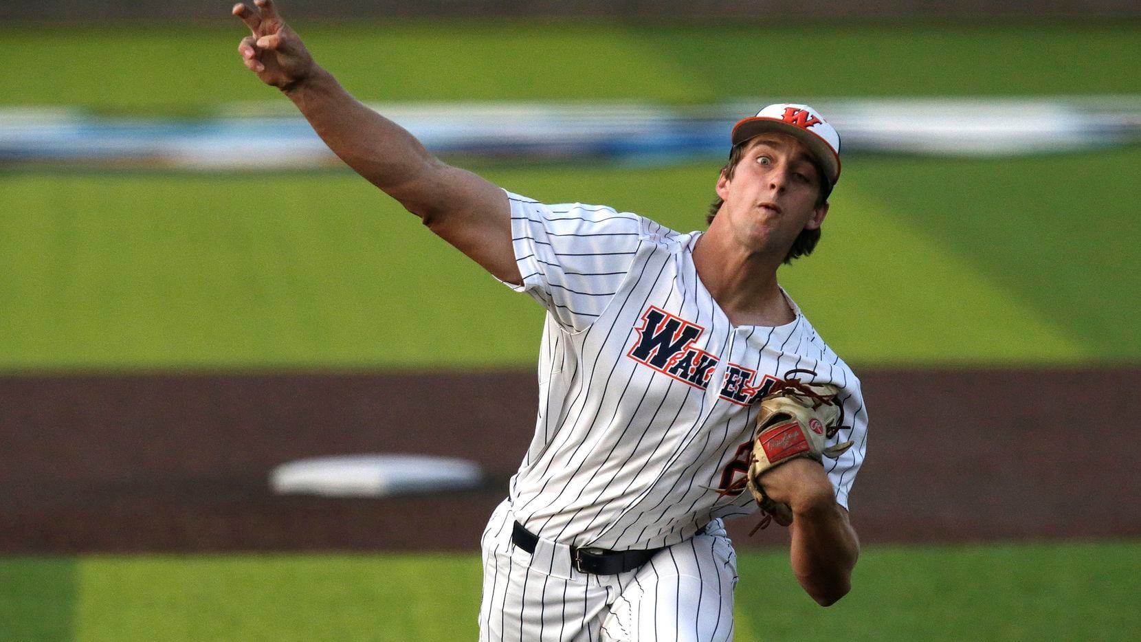 Wakeland High School pitcher Carson Priebe (22) delivers a pitch in the first inning as...