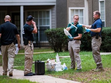 Lewisville police officers investigate a scene where a man stabbed a toddler on Sunday,...