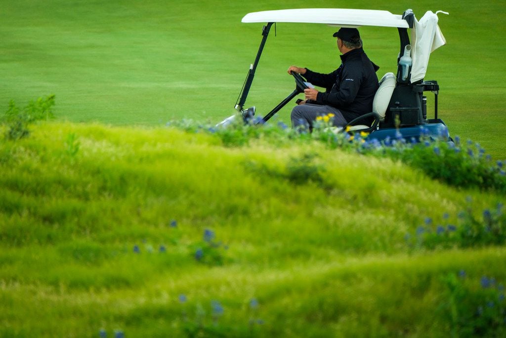 Dallas Mayor Mike Rawlings drives a golf cart to between fairways during the AT&T Byron Nelson golf tournament on Saturday, May 11, 2019, at Trinity Forest Golf Club in Dallas. (Smiley N. Pool/The Dallas Morning News)