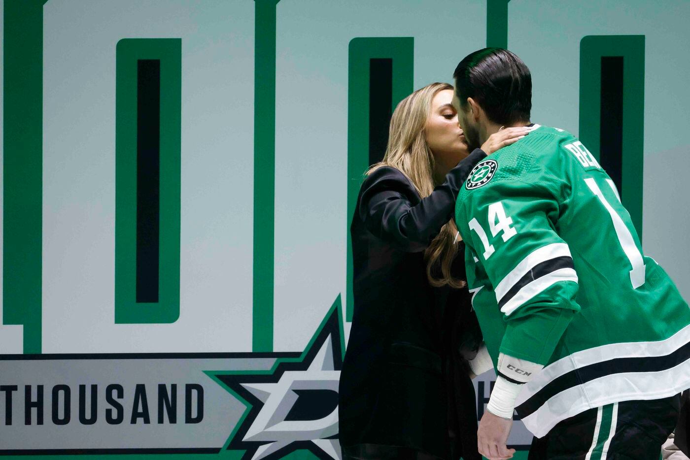 Dallas Stars left wing Jamie Benn (14) kisses his fiancee, Jessica Bennett during a ceremony...