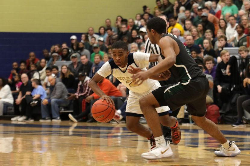 Little Elm's Javian Williams (2) attempts to drive past Prosper's Jerry McElroy during their...