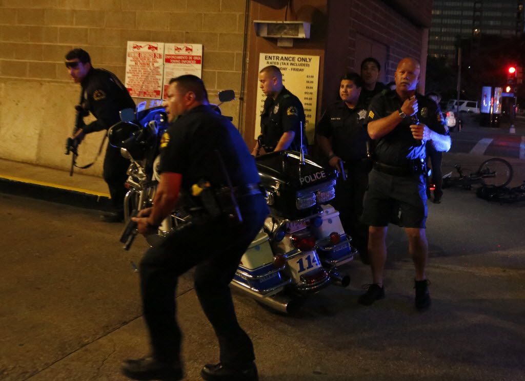  Dallas police respond after shots were fired at a Black Lives Matter rally in downtown...