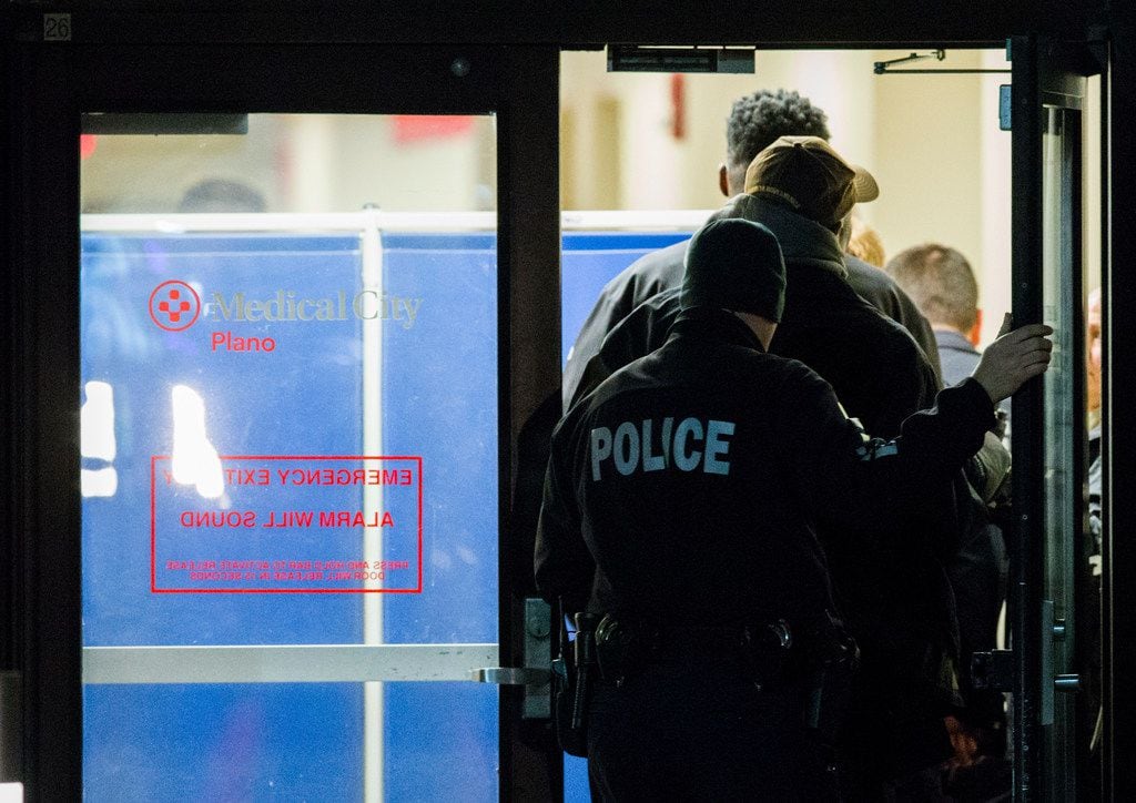 Police officers gather at the emergency room at Plano Medical City hospital after a...