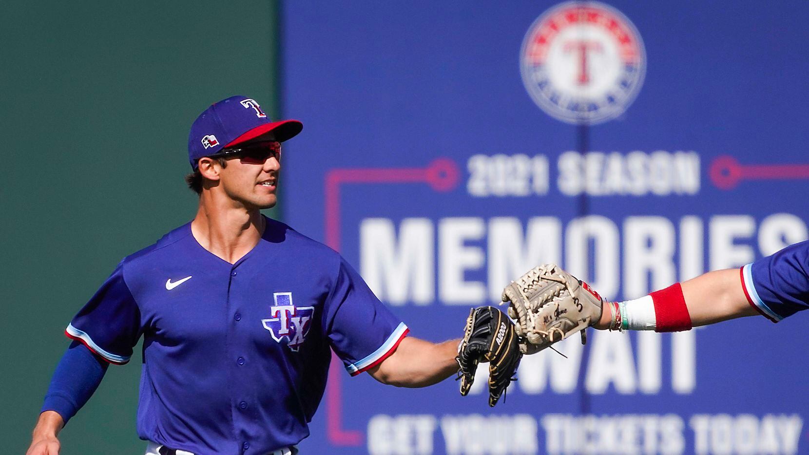 Texas Rangers outfielder Eli White celebrates after making a catch on a deep line drive off...