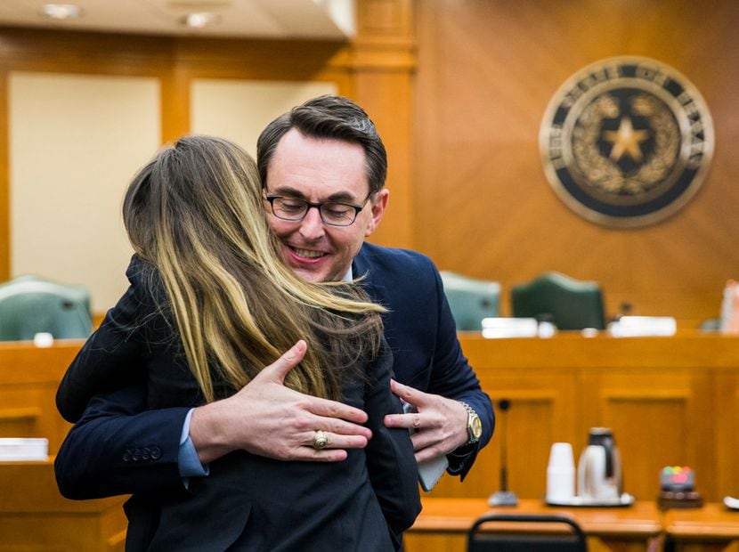 Eve Wiley (left) received a hug from  Justin Wood, director of the Senate Criminal Justice...