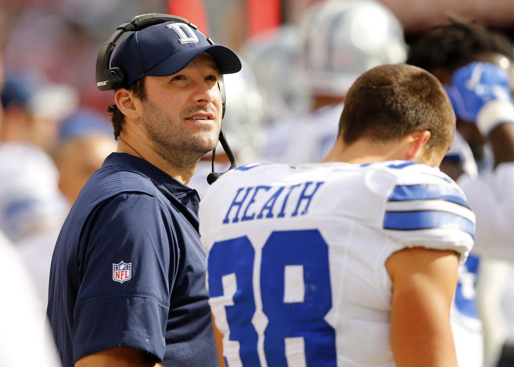 Dallas Cowboys quarterback Tony Romo (left) is seen on the sidelines with Dallas Cowboys...