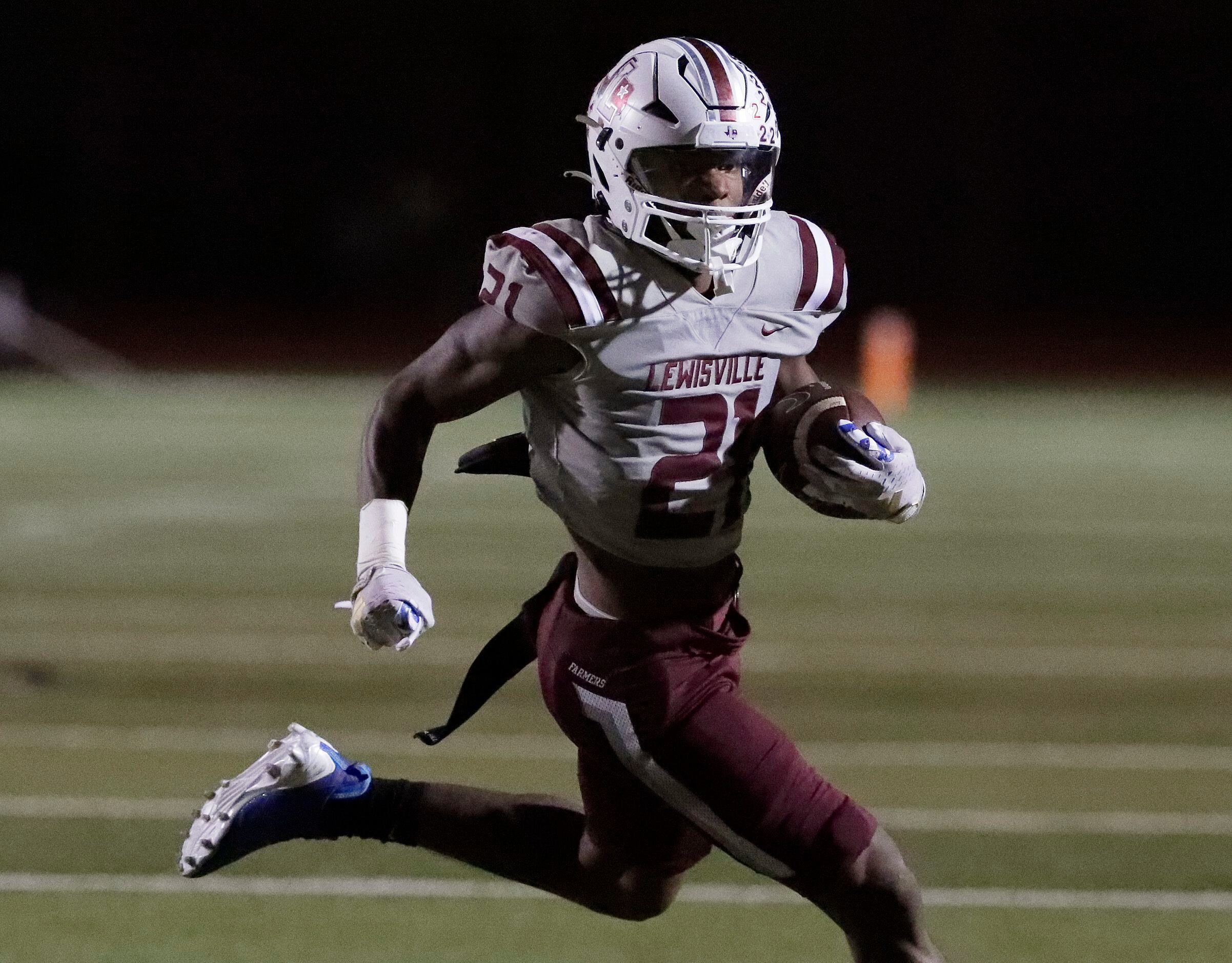 Lewisville High School running back Viron Ellison (21) carries the football during the first...