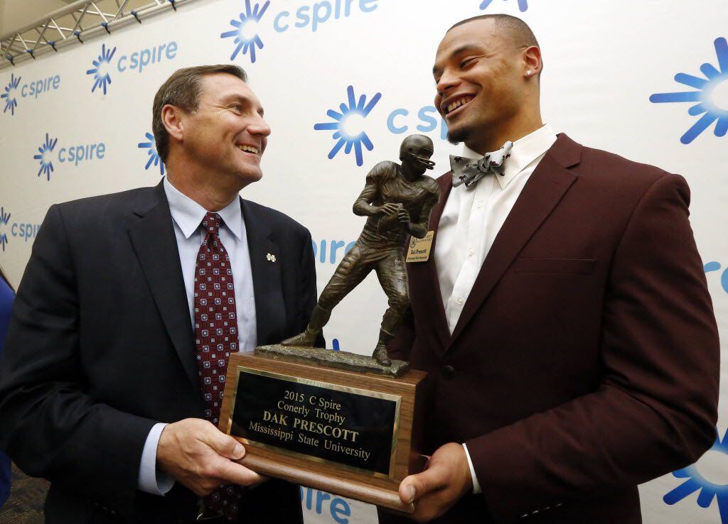 Mississippi State quarterback Dak Prescott and coach Dan Mullen hold the Conerly Trophy in...