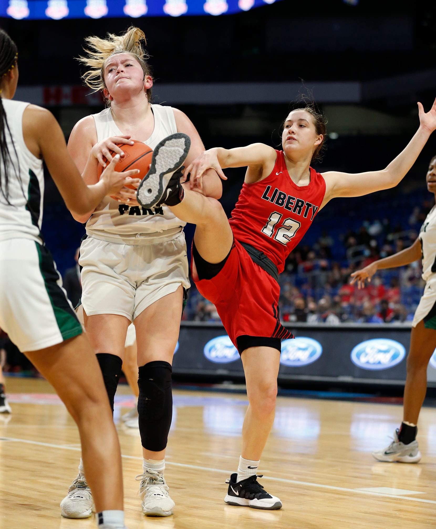Frisco Liberty Ashley Anderson #12 loses the battle for a rebound against Cedar Park Shelby...