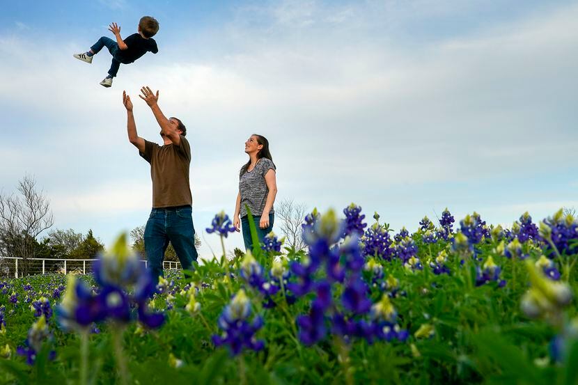 John Wallace tossed his son Ryan, 3, into the air as he and his wife Kim, stood in a field...