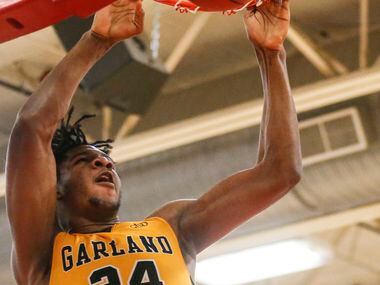 Garland High School Zuby Ejiofor (24) dunks the ball during the second quarter of the game...