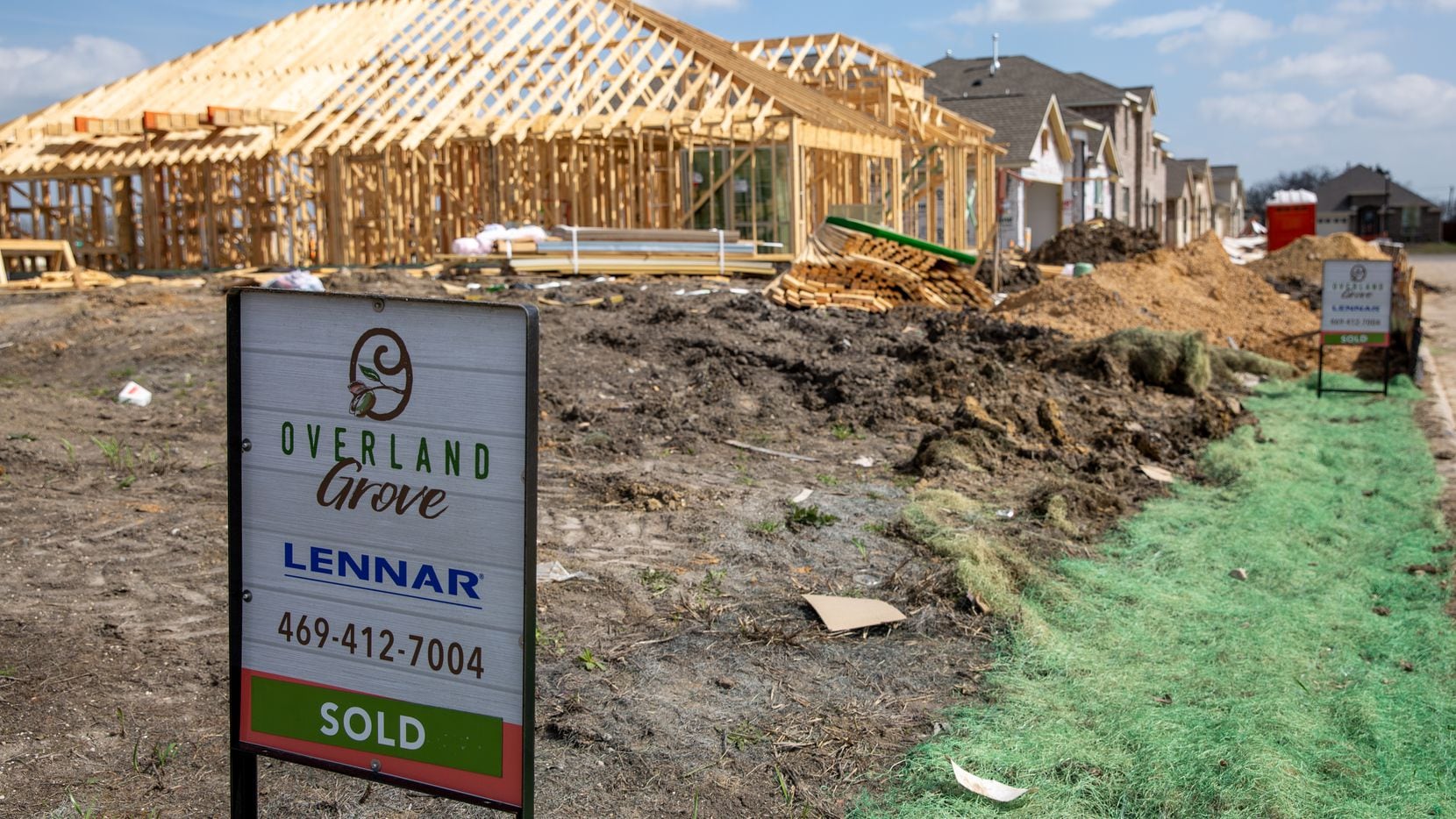 Availability signs line the streets in front of homes in various states of construction in...