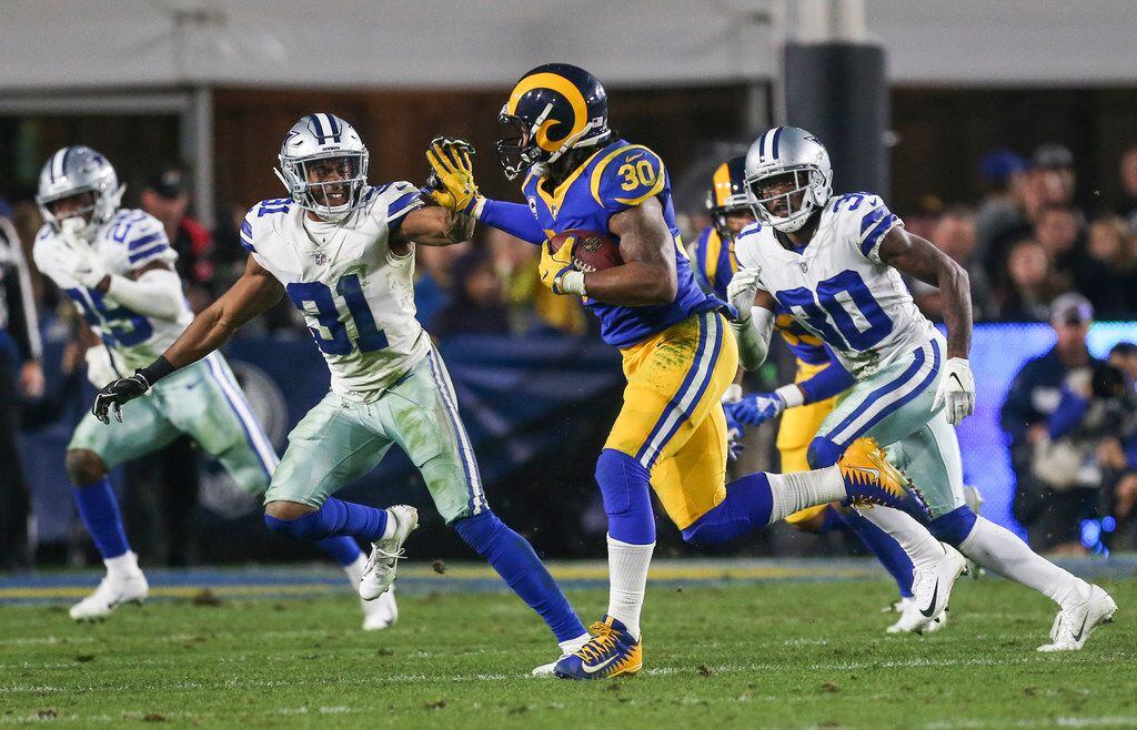 Los Angeles Rams running back Todd Gurley (30) attempts to make a break past Dallas Cowboys...