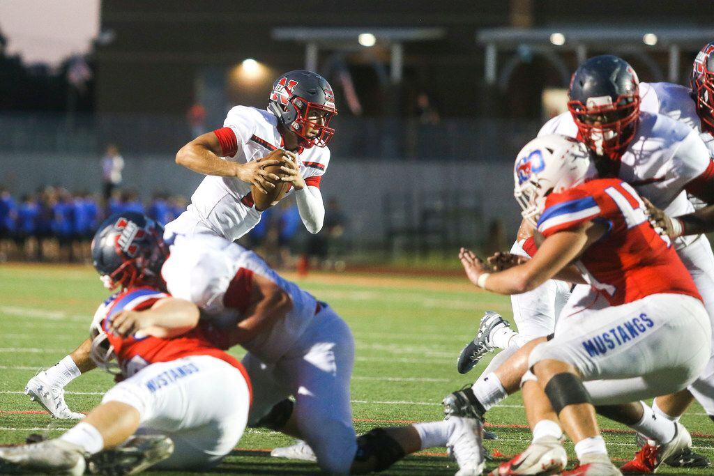 Northwest quarterback Austin Ahmad (15) carries the ball for a touchdown during the first...