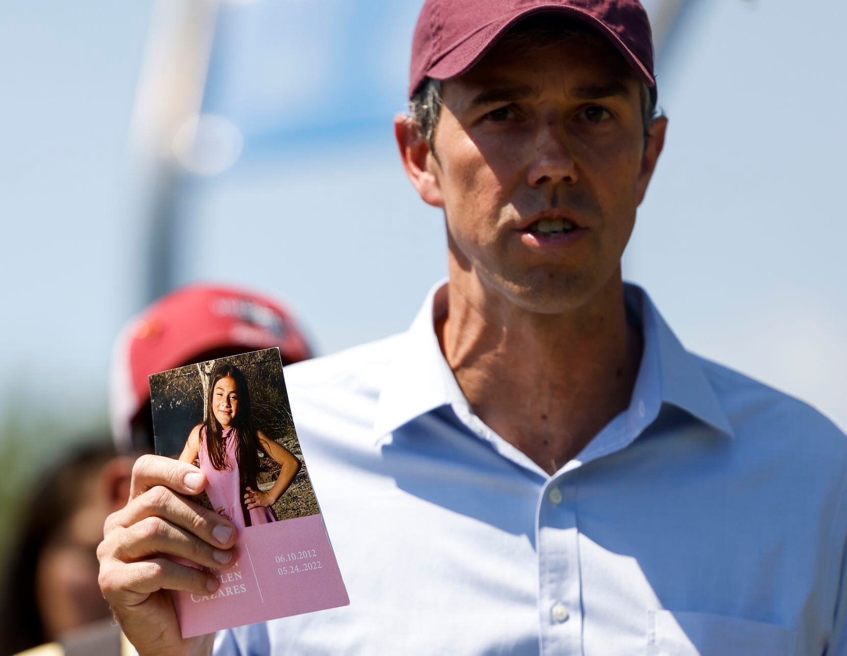 Democratic gubernatorial candidate Beto O'Rourke holds a card dedicated to one of the Uvalde...