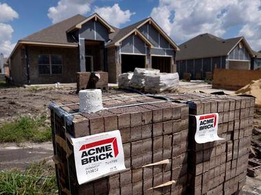Acme Bricks are stacked outside an Altura single family home under construction in the River...