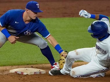 Infielder Yadiel Rivera is out at third base as Josh Jung applies the tag in an intrasquad game during Texas Rangers Summer Camp at Globe Life Field on Saturday, July 18, 2020.
