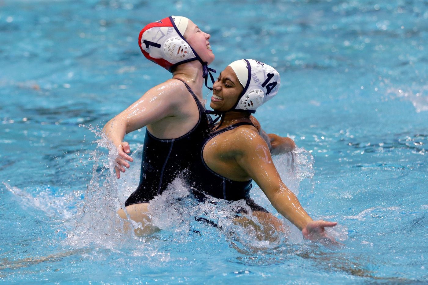 Flower MoundÕs Natalie Stearns (1) and Varsha Kolli chest bump in the water to celebrate...