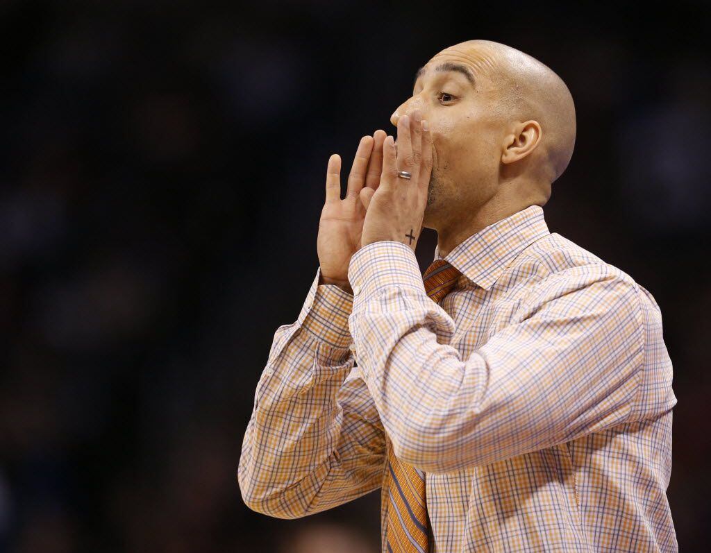 Texas Longhorns head coach Shaka Smart communicates to his players in a game against the...