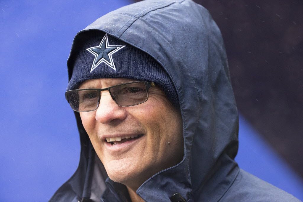 Dallas Cowboys defensive coordinator Rod Marinelli bundles up against a cold drizzle before...