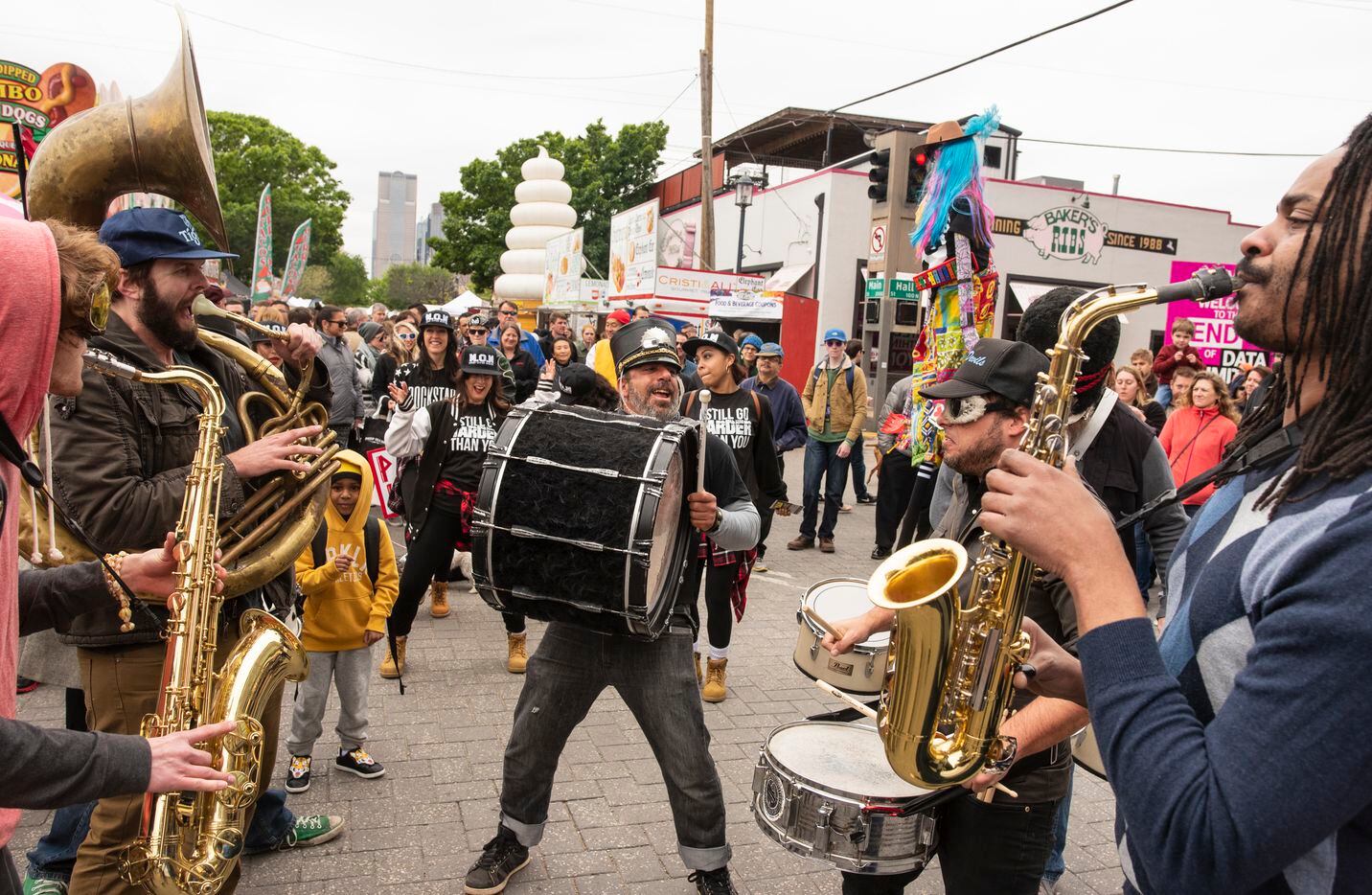 Musicians take a pause as they march through the Deep Ellum Arts Festival during the Deep...