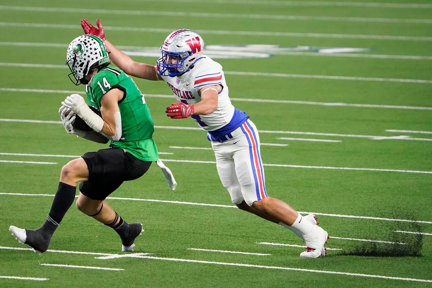Southlake Carroll wide receiver Brady Boyd (14) catches a pass on a 49-yard touchdown past Austin Westlake defensive back Jax Crockett during the first quarter of the Class 6A Division I state football championship game at AT&T Stadium on Saturday, Jan. 16, 2021, in Arlington, Texas. (Smiley N. Pool/The Dallas Morning News)