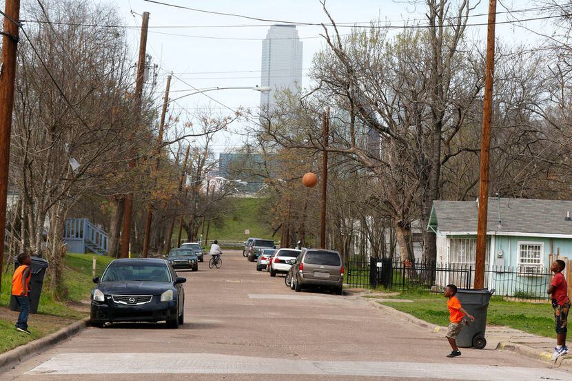 Kids play basketball in the Dallas Bottom District in southeast Dallas in a, 2018. file photo.