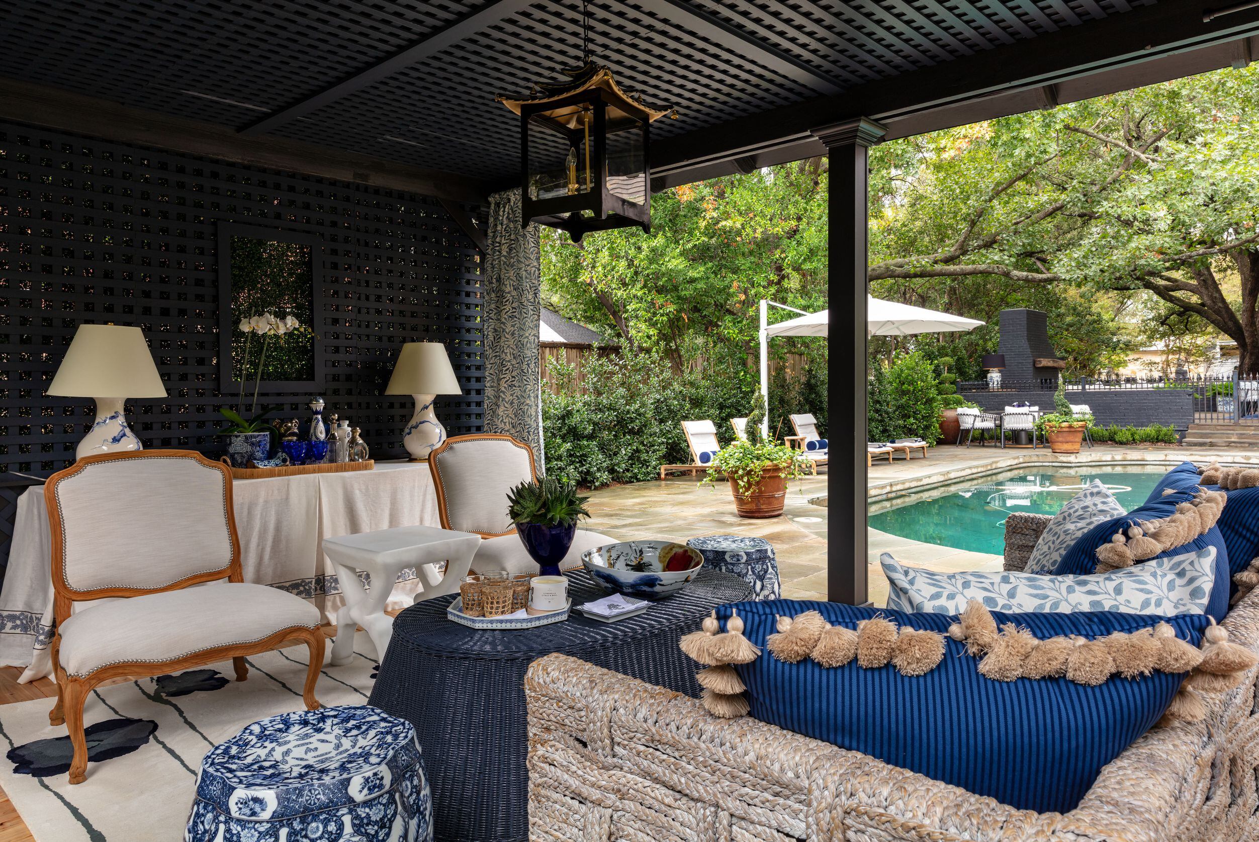 In the pool pavilion, Fiscus chose a Perennials rug, Morris & Co. drapery, a Josh Himmel...