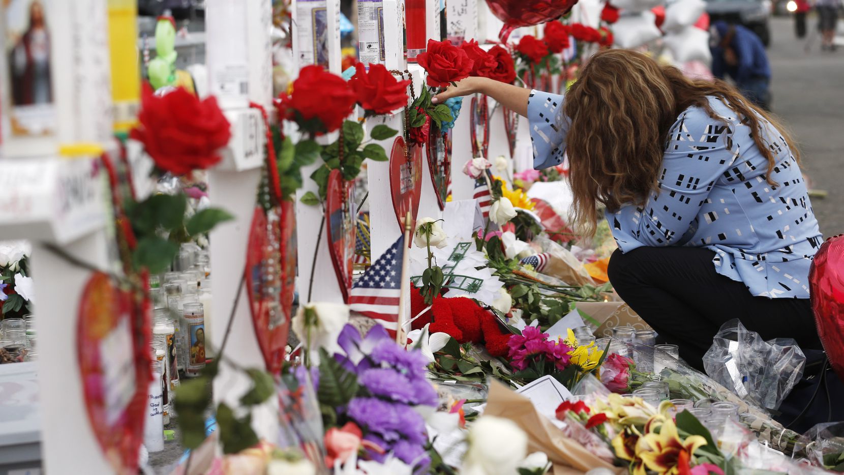 Gloria Garces of El Paso mourns for the loss of 2 family members at a makeshift memorial for...