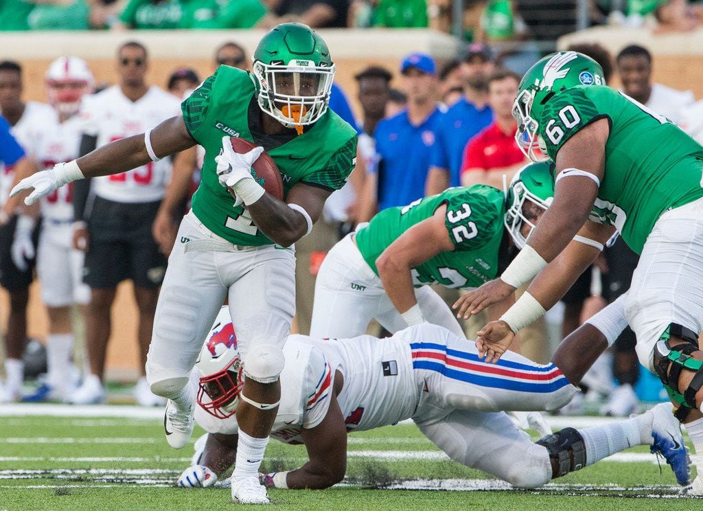 North Texas Mean Green running back Evan Johnson (7) makes a break with the ball during a...