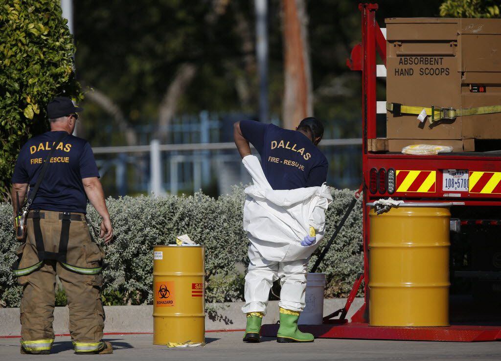 A Dallas Fire-Rescue HAZMAT team member removed a protective covering while responding to a...