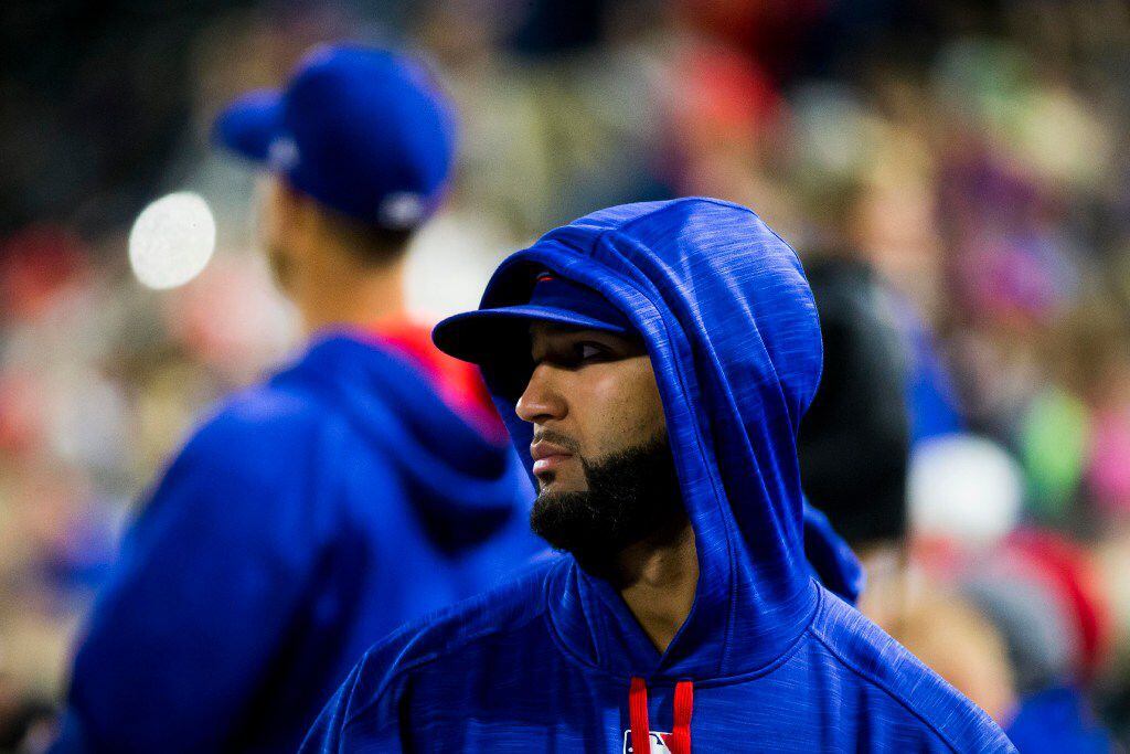 Texas Rangers right fielder Nomar Mazara wears a hoodie in the dugout during the fourth...