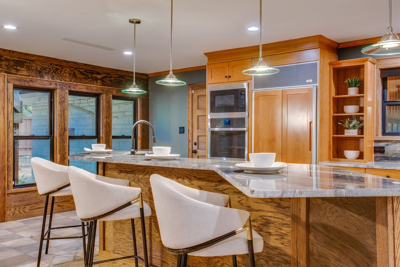 The modern kitchen features similar wood tones as that around the fireplace.