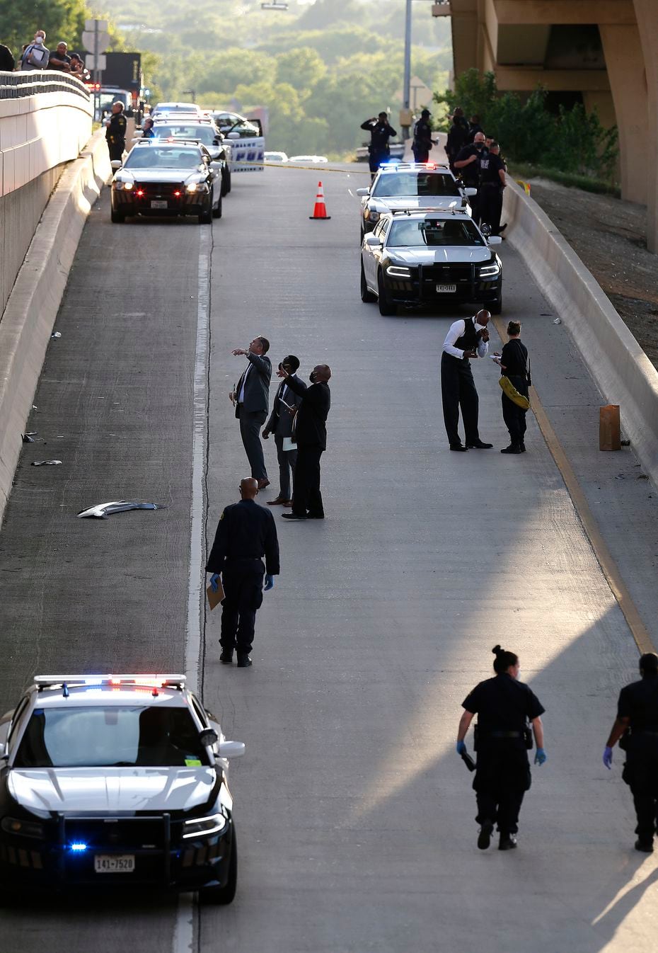 Police investigated after officers fatally shot a man armed with a replica gun Monday on the service road of Interstate 635 near Coit Road.