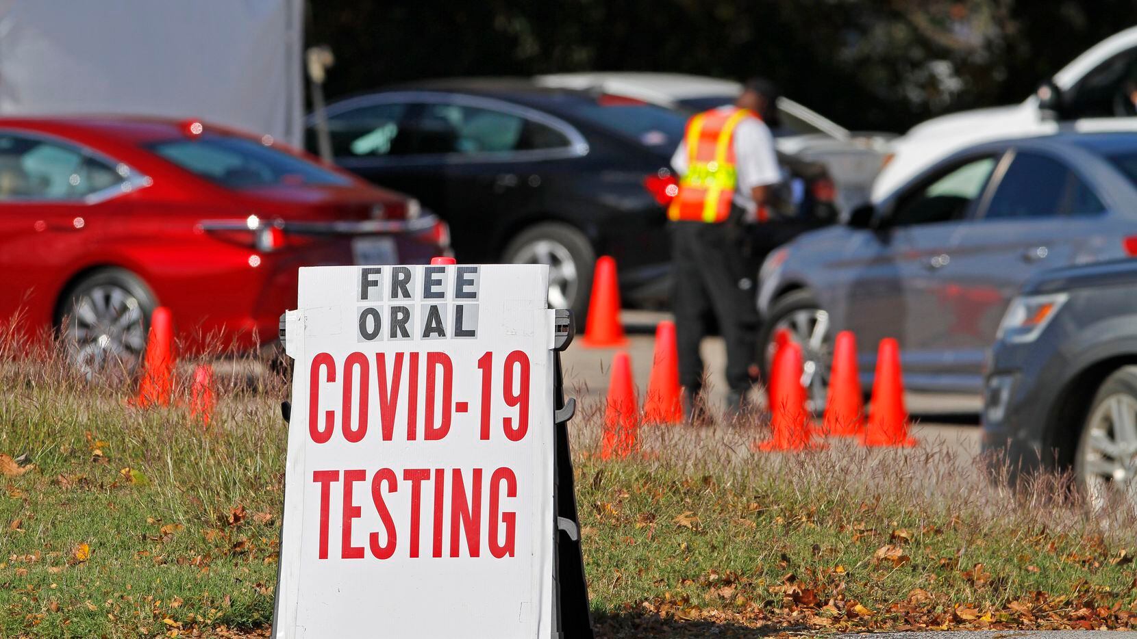 Cars wait in line to receive a COVID-19 oral testing kit at the Good Street Baptist Church testing site in Dallas, on Monday, Nov. 09, 2020. 