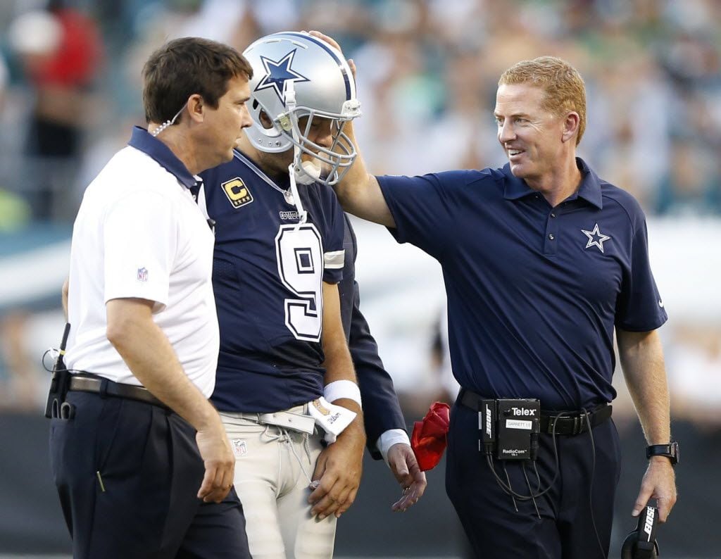 Dallas Cowboys head coach Jason Garrett talks to Dallas Cowboys quarterback Tony Romo (9)...