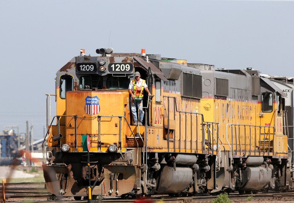 FILE - In this Thursday, July 20, 2017, file photo, a Union Pacific employee uses a remote control device to drive a locomotive in a rail yard in Council Bluffs, Iowa. Union Pacific Corp. reports earnings, Thursday, Jan. 25, 2018. (AP Photo/Nati Harnik, File)