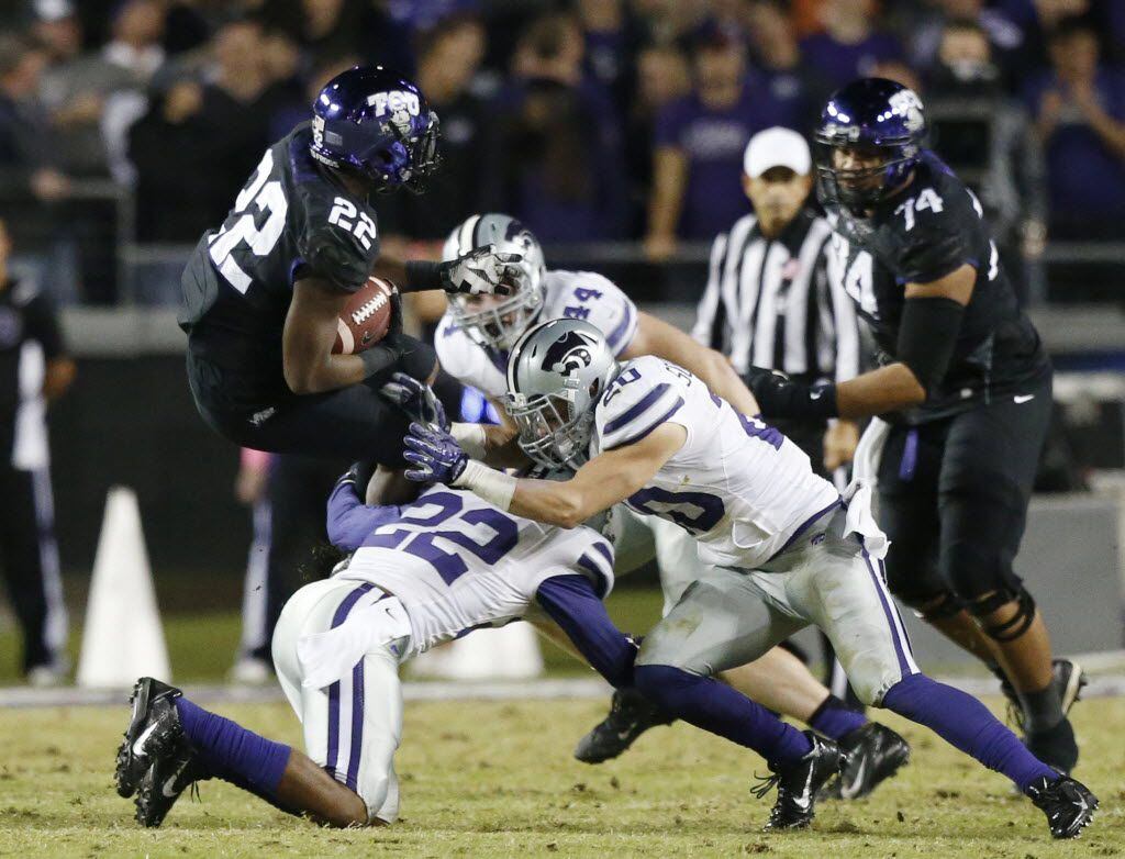 TCU running back Aaron Green (22) is tackled by Kansas State defenders while rushing the ball in the second quarter during an NCAA college football game between the Kansas State Wildcats and TCU Horned Forgs at Amon G. Carter Stadium in Fort Worth Saturday November 8, 2014. TCU beat Kansas State 41-20. (Andy Jacobsohn/The Dallas Morning News)