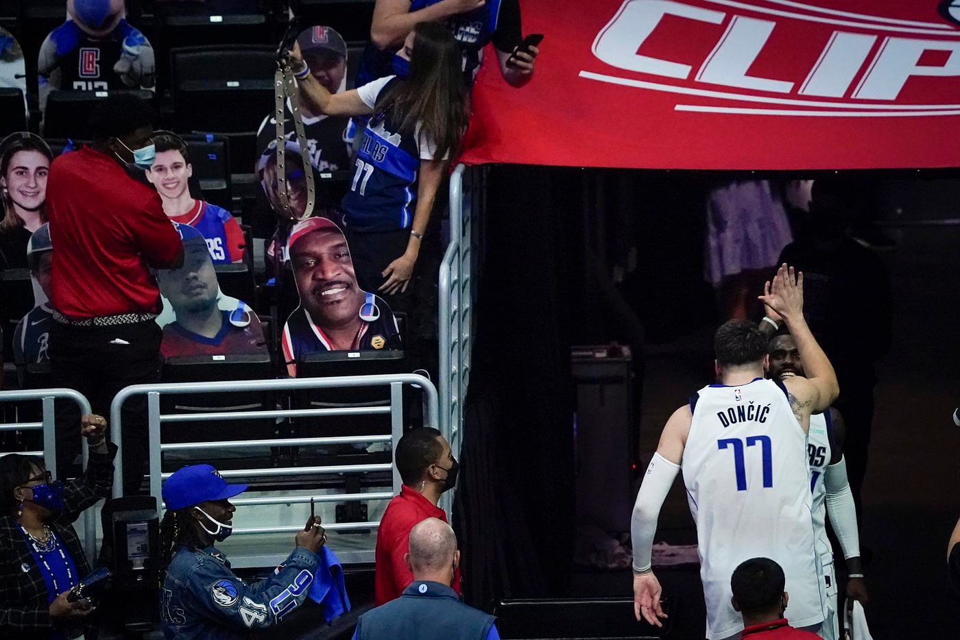 Dallas Mavericks guard Luka Doncic (77) celebrates with forward Tim Hardaway Jr. (11) as they leave the court after the Mavericks 127-121 victory over the LA Clippers in an NBA playoff basketball game at Staples Center on Wednesday, May 26, 2021, in Los Angeles. 