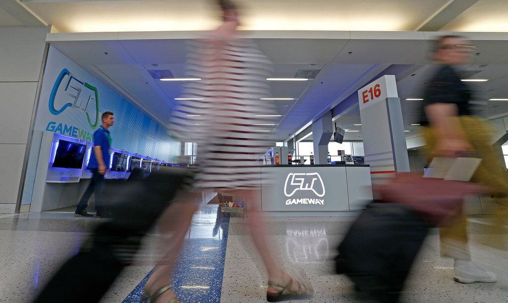 Travelers walk by Gameway inside Terminal E of Dallas/Fort Worth International Airport in DFW Airport, Texas, Friday, July 6, 2018.