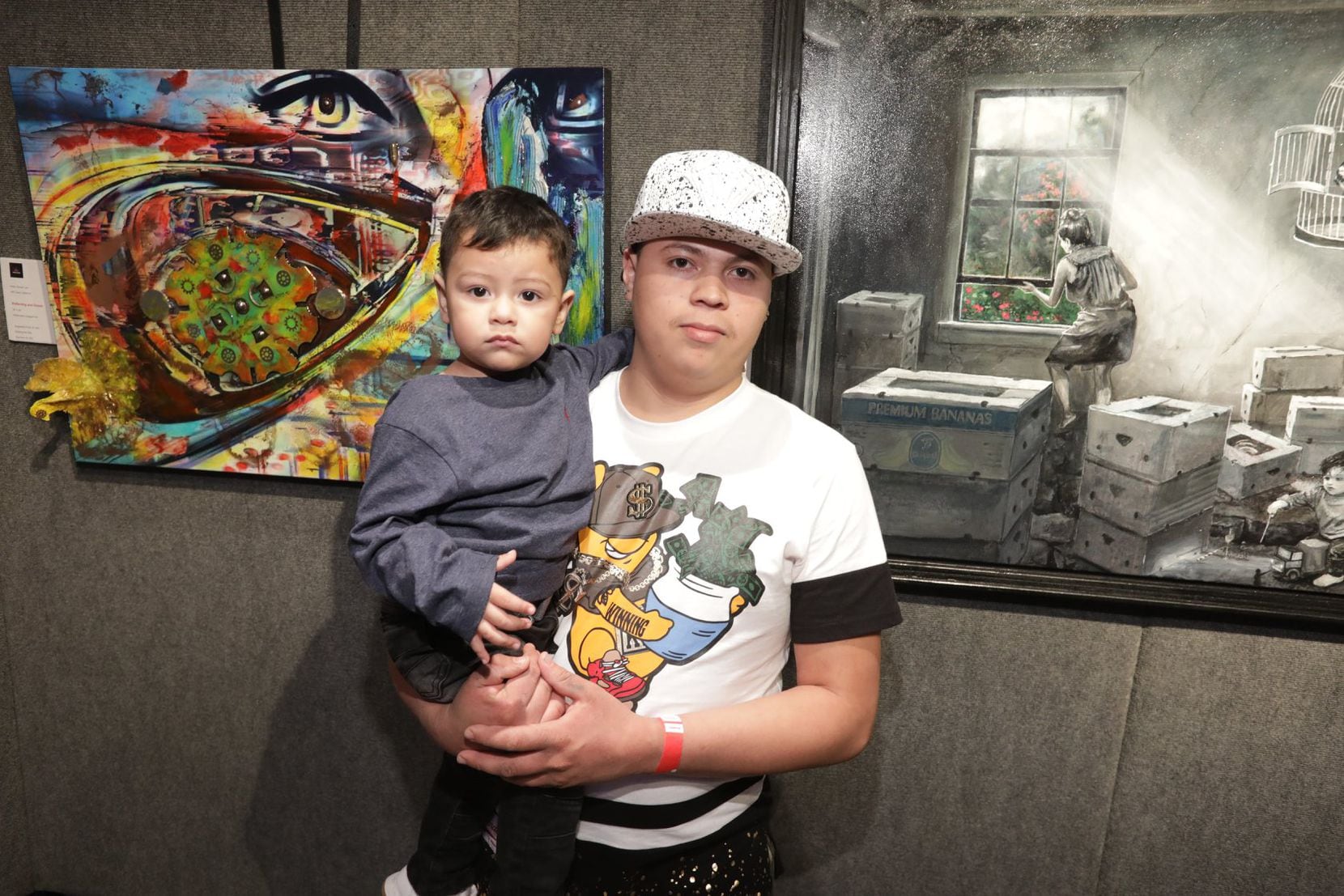 Over Selvin's right shoulder is the piece that was inspired by his story, created by Denise...