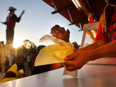 People step up to buy turkey legs in Big Tex Circle during the State Fair of Texas at Fair...