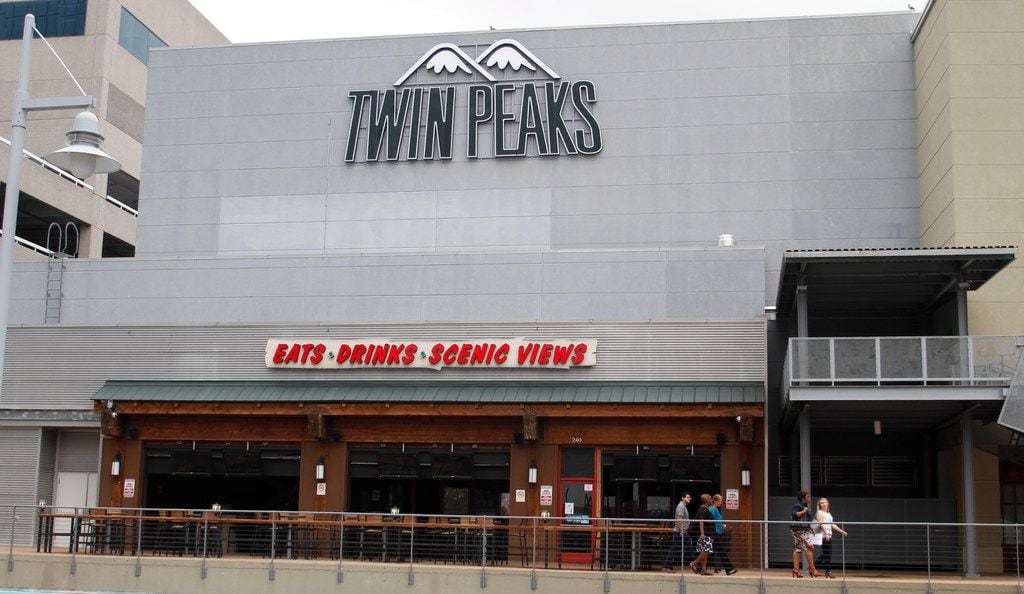 Office workers walk by Twin Peaks restaurant in Mockingbird Station in Dallas on Sept. 12,...
