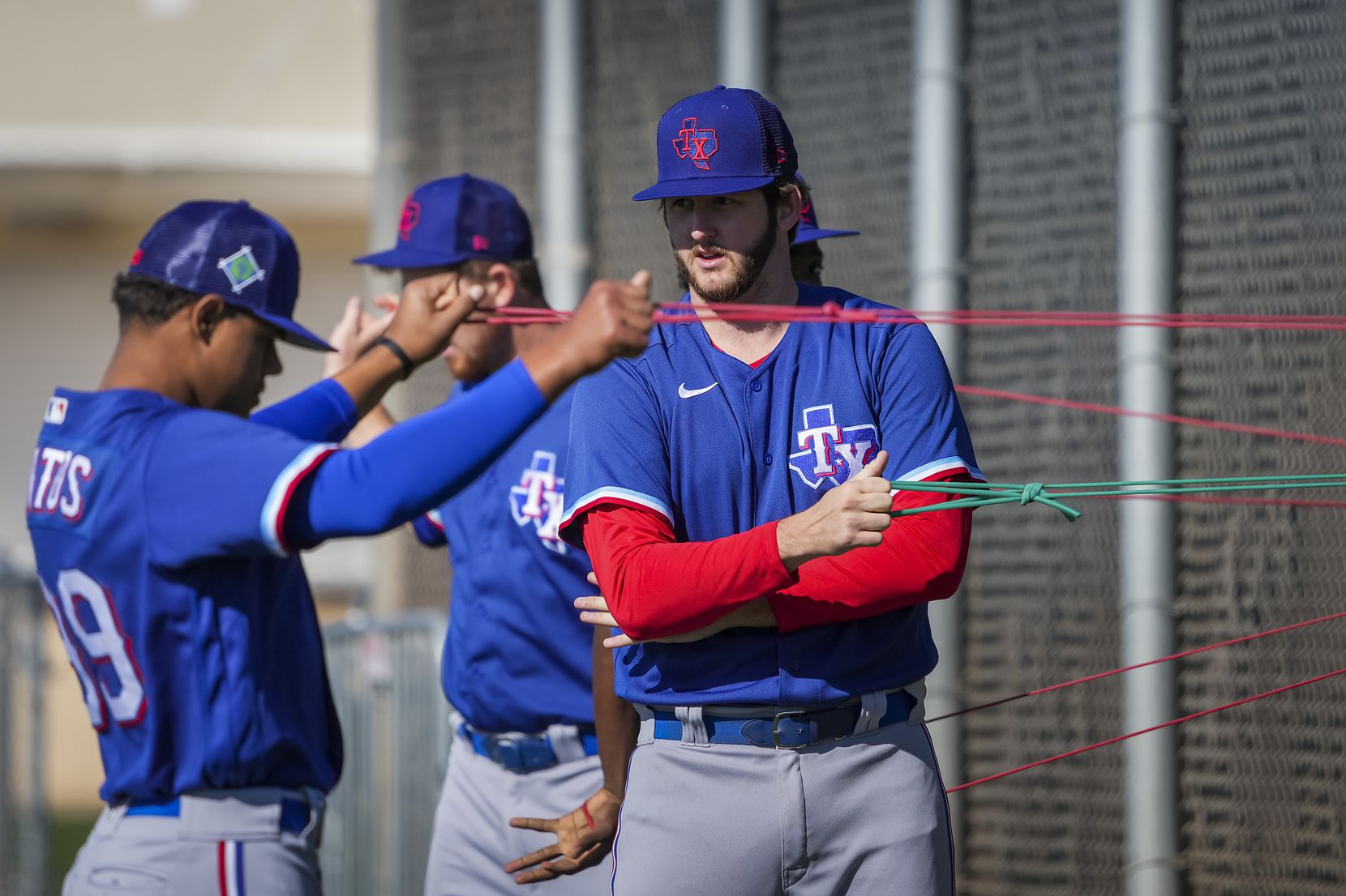 Pitcher Justin Slaten (center) stretches with teammates, including Winston Santos (left),...