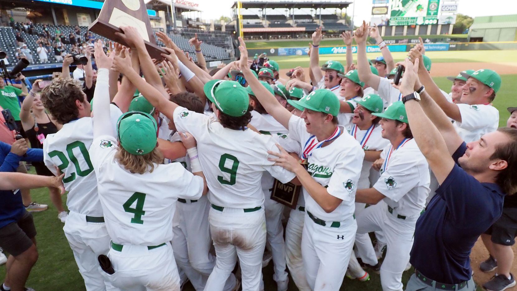 Southlake Carroll players hoist the first place trophy after defeating San Antonio Reagan in...