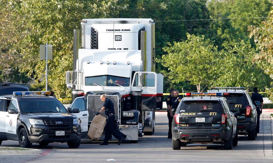Law enforcement found eight migrants dead in the back of a tractor-trailer parked behind a...