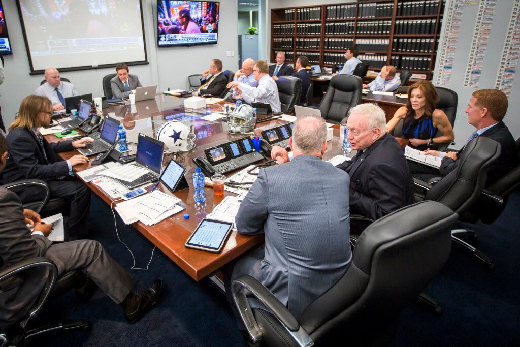 Dallas Cowboys owner Jerry Jones (center) talks to his son, executive vice president/COO...