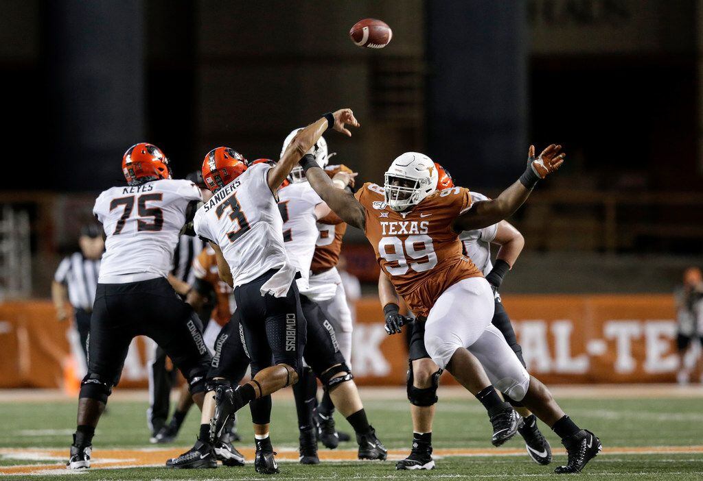 FILE - Oklahoma State quarterback Spencer Sanders (3) throws a pass under pressure by Texas...